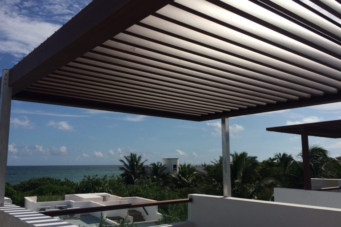 A louvered patio covering on a beachfront property