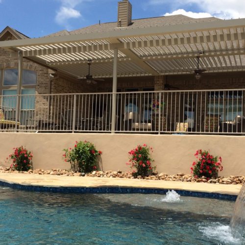 a louvered patio covering in a residential backyard 