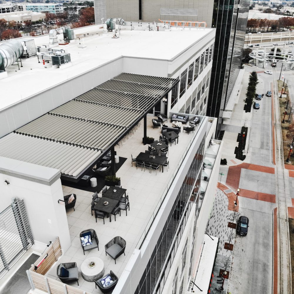 Overhead view of a residential building with a pergola shading system on the rooftop deck