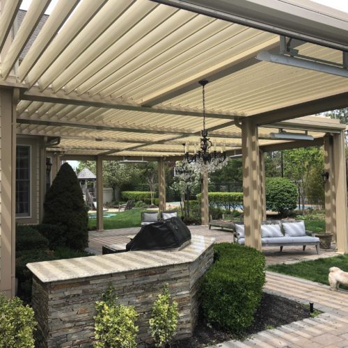 A sprawling backyard with a custom patio cover shading the entire walkway