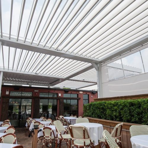 custom commercial louvered roof system shading outdoor dining area