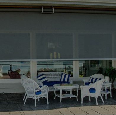 A beachfront patio with an Equinox patio covering
