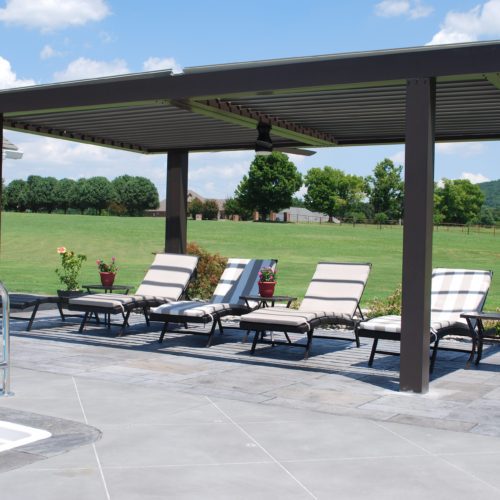 an equinox pergola shading an outdoor seating area 