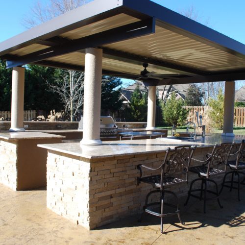 outdoor grilling and dining area covered by an equinox pergola