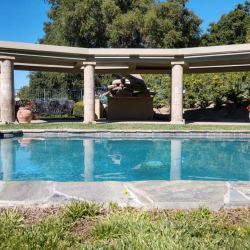 An alternative view of the residential backyard with an 8 column pergola and pool