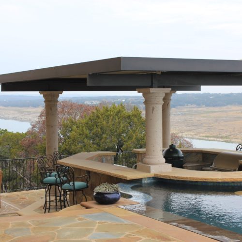 A residential backyard with a custom pergola providing shade to the outdoor seating area. 