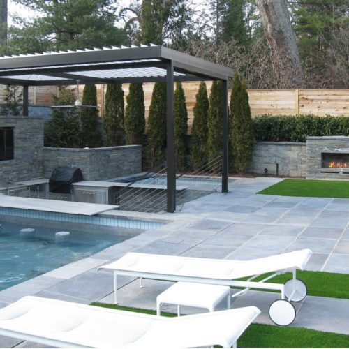 A luxurious patio with a pool, enhanced by Equinox Roofing features.