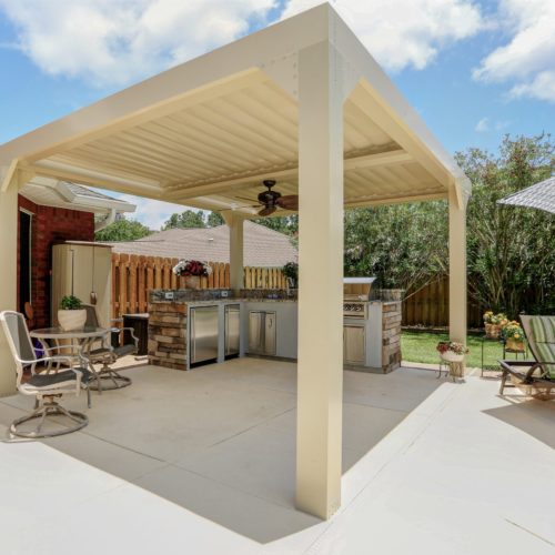 An equinox louvered pergola provides shade to a residential patio in the summertime