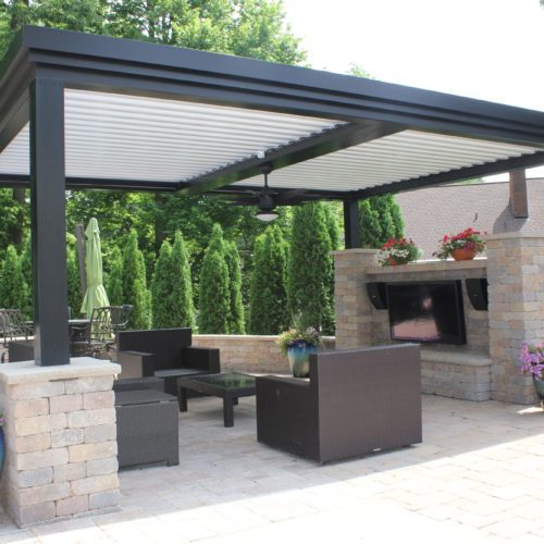 a black and white equinox motorized patio covering with open louvers in a residential backyard