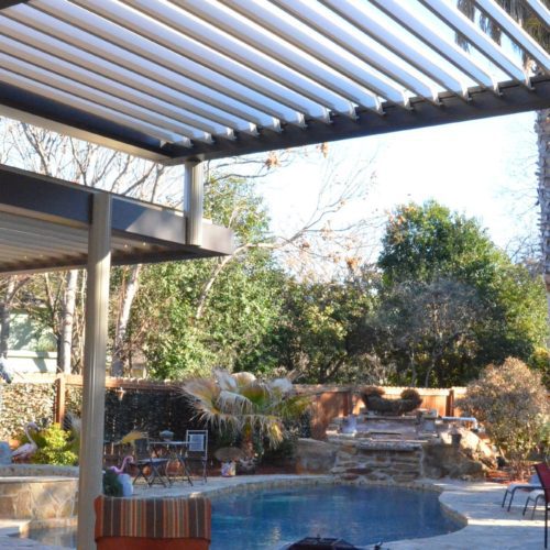 a residential pool area is shaded by an equinox open louvered roof system