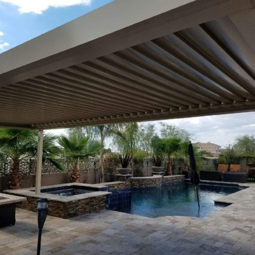 closed louvers on a tan pergola covering a residential pool area